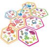 Несколько соединенных между собой шестиугольных карт Dobble Connect с различными красочными символами, включая пончики, клевер и наушники, демонстрирующие игровую механику.