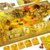 A full view of the Stone Age board game board with resource tokens, cards and dice creating an ancient world feel.